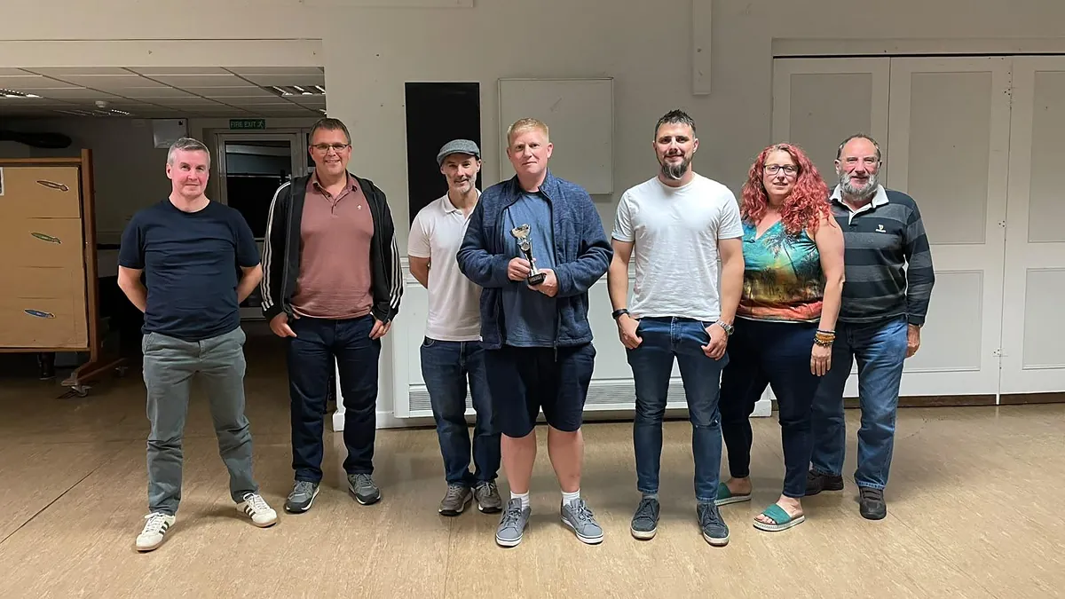 Seven Quoker players lined up at the end of the night, the winner holding the trophy.
